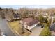 Aerial view of a home with a three car garage, long driveway, and manicured lawn at 6528 Hedback Dr, Indianapolis, IN 46220