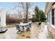 Backyard patio featuring outdoor seating and mature trees in a well-maintained space at 6528 Hedback Dr, Indianapolis, IN 46220