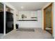 Finished basement area with a kitchen area, cabinets, sink, rug, and doorway to the bathroom at 6528 Hedback Dr, Indianapolis, IN 46220