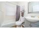 Bright bathroom featuring a white vanity, toilet, tub, and framed mirror at 6528 Hedback Dr, Indianapolis, IN 46220