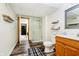 Modern bathroom with a glass shower, toilet, wood vanity, and patterned floor at 6528 Hedback Dr, Indianapolis, IN 46220