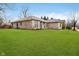 Beautifully landscaped home with a lush green lawn at 6528 Hedback Dr, Indianapolis, IN 46220