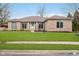 Charming brick home with manicured lawn and inviting front entrance at 6528 Hedback Dr, Indianapolis, IN 46220