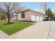 Spacious three-car garage with a large driveway and well-maintained landscaping at 6528 Hedback Dr, Indianapolis, IN 46220