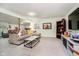 Cozy living room in the basement with a sectional sofa, coffee table, and entertainment center at 6528 Hedback Dr, Indianapolis, IN 46220
