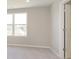 Light-filled bedroom with neutral walls, plush carpet, and a view of the neighborhood at 7181 Barrett Dr, Brownsburg, IN 46112