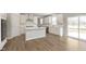 Modern kitchen featuring white cabinets, a center island, stainless steel appliances, and durable floors at 7181 Barrett Dr, Brownsburg, IN 46112