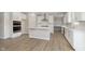 Modern kitchen with white cabinets, stainless steel appliances, a center island, and durable floors at 7181 Barrett Dr, Brownsburg, IN 46112