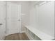 Mudroom featuring beadboard wall paneling, coat hooks, a built-in bench, and cubby storage at 7181 Barrett Dr, Brownsburg, IN 46112