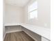 Home office with white desk, vinyl floor, and a large window at 7181 Barrett Dr, Brownsburg, IN 46112