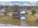 Aerial view of a home featuring a large front yard, driveway, mature trees, and neighborhood at 7463 Pebblebrooke W Dr, Indianapolis, IN 46236