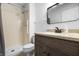 Bathroom featuring a shower with grab bar and a wood vanity with mirror at 7463 Pebblebrooke W Dr, Indianapolis, IN 46236