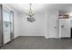 Bright dining area with neutral colors, tile floors, and a modern light fixture at 7463 Pebblebrooke W Dr, Indianapolis, IN 46236