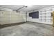 Spacious garage featuring a neutral-tone door, gray cabinets, and adjustable shelving for ample storage at 7463 Pebblebrooke W Dr, Indianapolis, IN 46236