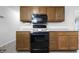 Traditional kitchen featuring oak cabinets, black appliances and light countertops at 7463 Pebblebrooke W Dr, Indianapolis, IN 46236