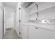 Bright laundry room with shelving, washer, dryer and doorway to another room at 7463 Pebblebrooke W Dr, Indianapolis, IN 46236