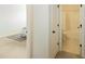 Shot of bathroom from bedroom shows combination tub/shower, toilet, and vanity with solid surface countertops at 761 Stone Trace Ct, Avon, IN 46123