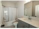 Bathroom with combination tub and shower, framed mirror and vanity with solid surface countertops at 761 Stone Trace Ct, Avon, IN 46123