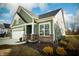 Charming green home featuring a brick foundation, attached two-car garage, and well manicured front yard at 761 Stone Trace Ct, Avon, IN 46123