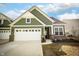 Charming green home featuring a brick foundation and an attached two-car garage and long drive at 761 Stone Trace Ct, Avon, IN 46123