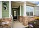 Inviting front porch with brick accents, white columns, and a classic black front door at 761 Stone Trace Ct, Avon, IN 46123