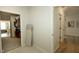 Hallway with laundry room access and view to carpeted bedroom at 761 Stone Trace Ct, Avon, IN 46123