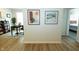 Hallway featuring stylish decor, leading to a brightly lit office space and a comfortable bedroom at 761 Stone Trace Ct, Avon, IN 46123