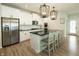 Bright kitchen featuring stainless steel appliances, white cabinets, and a spacious island with barstool seating at 761 Stone Trace Ct, Avon, IN 46123
