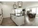 Bright, open-concept kitchen featuring a large island with black countertops and modern pendant lighting at 761 Stone Trace Ct, Avon, IN 46123