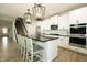 Stylish kitchen with stainless steel appliances, a black countertop island, and pendant lighting at 761 Stone Trace Ct, Avon, IN 46123