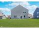 Expansive backyard featuring a lush lawn and rear view of the home with sliding glass doors at 7658 Hillway Dr, Indianapolis, IN 46113