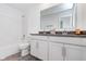 Bright bathroom featuring a double vanity with modern fixtures and a shower-tub combo at 7658 Hillway Dr, Indianapolis, IN 46113