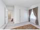 Bedroom with grey carpet, neutral walls, and modern window coverings at 7658 Hillway Dr, Indianapolis, IN 46113