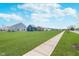 Well-maintained community with sidewalks and manicured lawns under a blue sky at 7658 Hillway Dr, Indianapolis, IN 46113