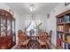 Traditional dining room with elegant wood furniture, a floral rug, and ample natural light, ideal for Gathering gatherings at 7658 Hillway Dr, Indianapolis, IN 46113