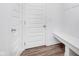 Functional entryway with built-in bench, storage, and wood-look flooring for added convenience at 7658 Hillway Dr, Indianapolis, IN 46113