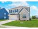 Two-story home with blue shutters, a well-maintained lawn, and a two-car garage, blending traditional and modern design elements at 7658 Hillway Dr, Indianapolis, IN 46113