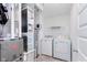 Convenient laundry room with modern washer and dryer, shelving, and organized utility systems at 7658 Hillway Dr, Indianapolis, IN 46113