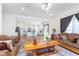 Inviting living room seamlessly connects to the kitchen, featuring wood floors and ample natural light at 7658 Hillway Dr, Indianapolis, IN 46113