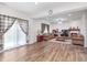 Spacious living room featuring wood-look floors, a cozy fireplace, and large windows that flood the space with natural light at 7658 Hillway Dr, Indianapolis, IN 46113