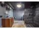 A modern bathroom featuring a tiled walk-in shower and a wood vanity at 7859 Moore Rd, Gosport, IN 47433