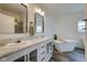 Luxurious bathroom with double vanity, a freestanding soaking tub and modern fixtures at 7859 Moore Rd, Gosport, IN 47433