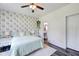 Charming bedroom featuring a floral accent wall and natural light at 7859 Moore Rd, Gosport, IN 47433