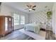 Serene bedroom with floral wallpaper accent wall, ample natural light, and stylish wood-look floors at 7859 Moore Rd, Gosport, IN 47433
