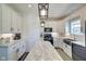 Modern kitchen with white cabinets, marble countertops, stainless steel appliances, and a farmhouse sink at 7859 Moore Rd, Gosport, IN 47433