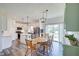Open kitchen and dining area with white cabinetry, stainless steel appliances, and a center island at 7859 Moore Rd, Gosport, IN 47433
