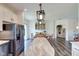Bright kitchen featuring an island with a marble countertop and a stainless steel refrigerator at 7859 Moore Rd, Gosport, IN 47433