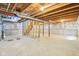 Spacious unfinished basement with visible ceiling rafters and cement flooring at 8074 Carina Dr, Indianapolis, IN 46268