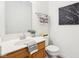 Bright powder room with modern sink, wooden cabinets, and decorative black and white wall art at 8074 Carina Dr, Indianapolis, IN 46268