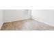 Bright bedroom featuring light hardwood floors, white walls and a sunny window at 8074 Carina Dr, Indianapolis, IN 46268